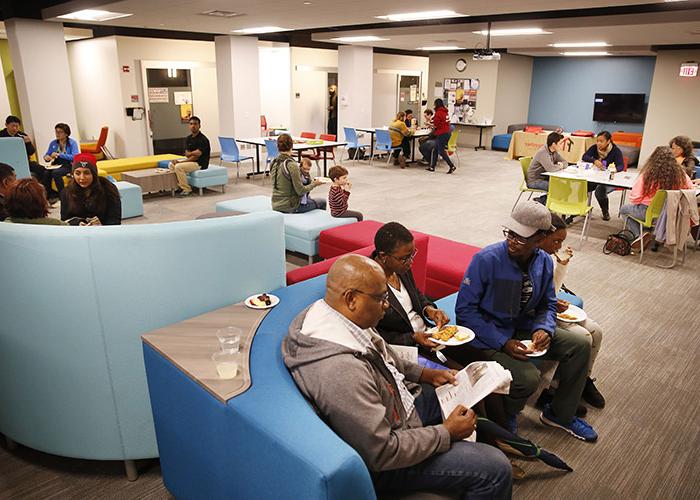 Groups of people eat and talk in the Center for Student Diversity and Inclusion